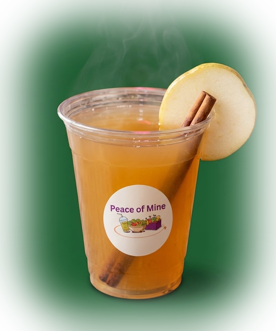 Warm pear cider in a Peace of Mine cup with a cinnamon stick and a pear slice, steaming