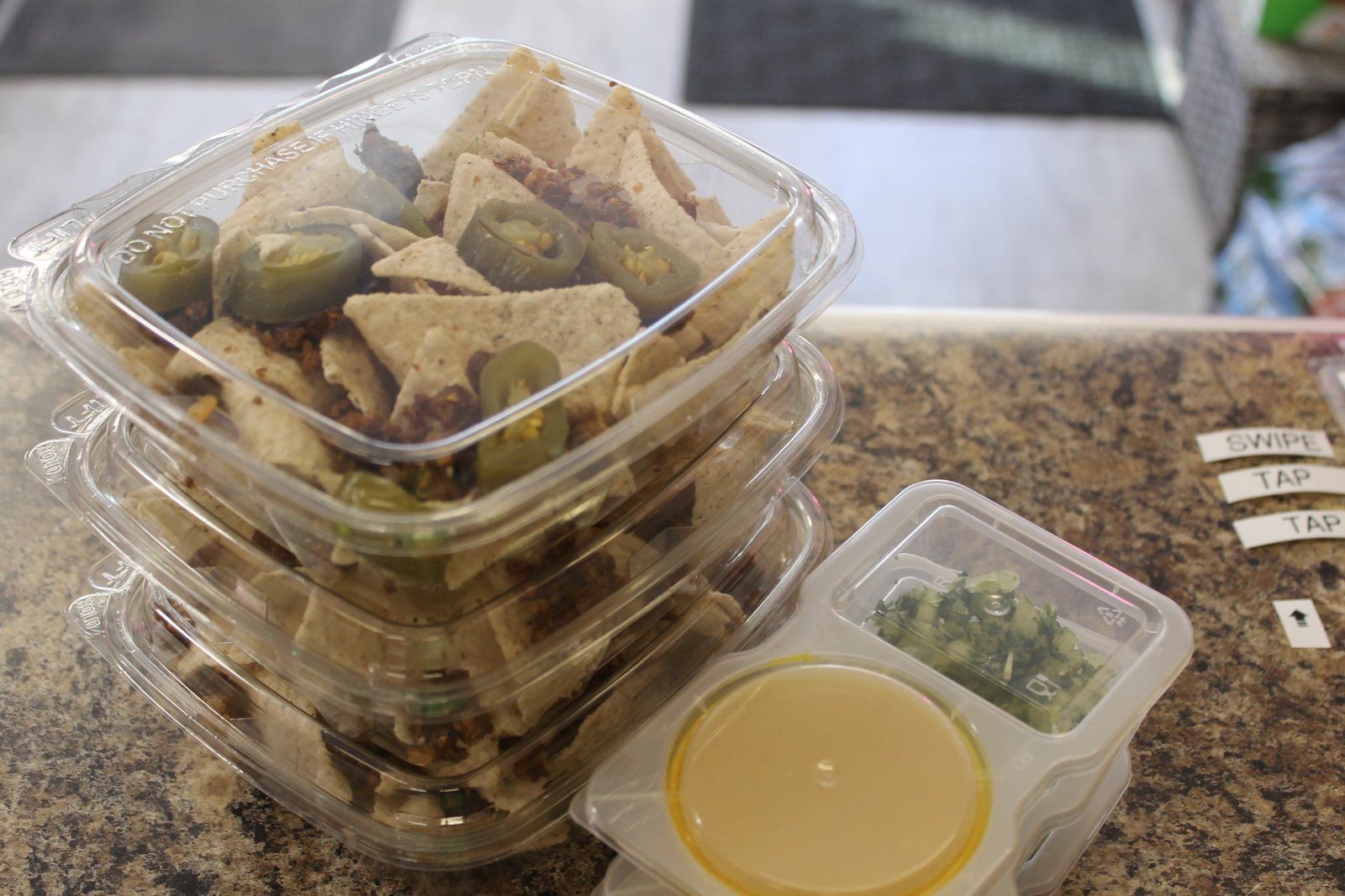 Friday snack boxes of tortilla chips, plant-based taco crumble and jalapeños with cheese sauce on the side